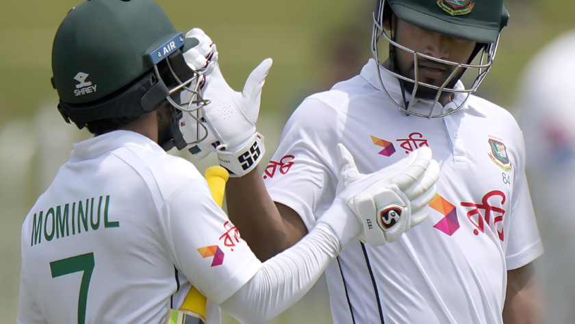 Najmul Hossain Shanto and Mominul Haque celebrating on the cricket field.