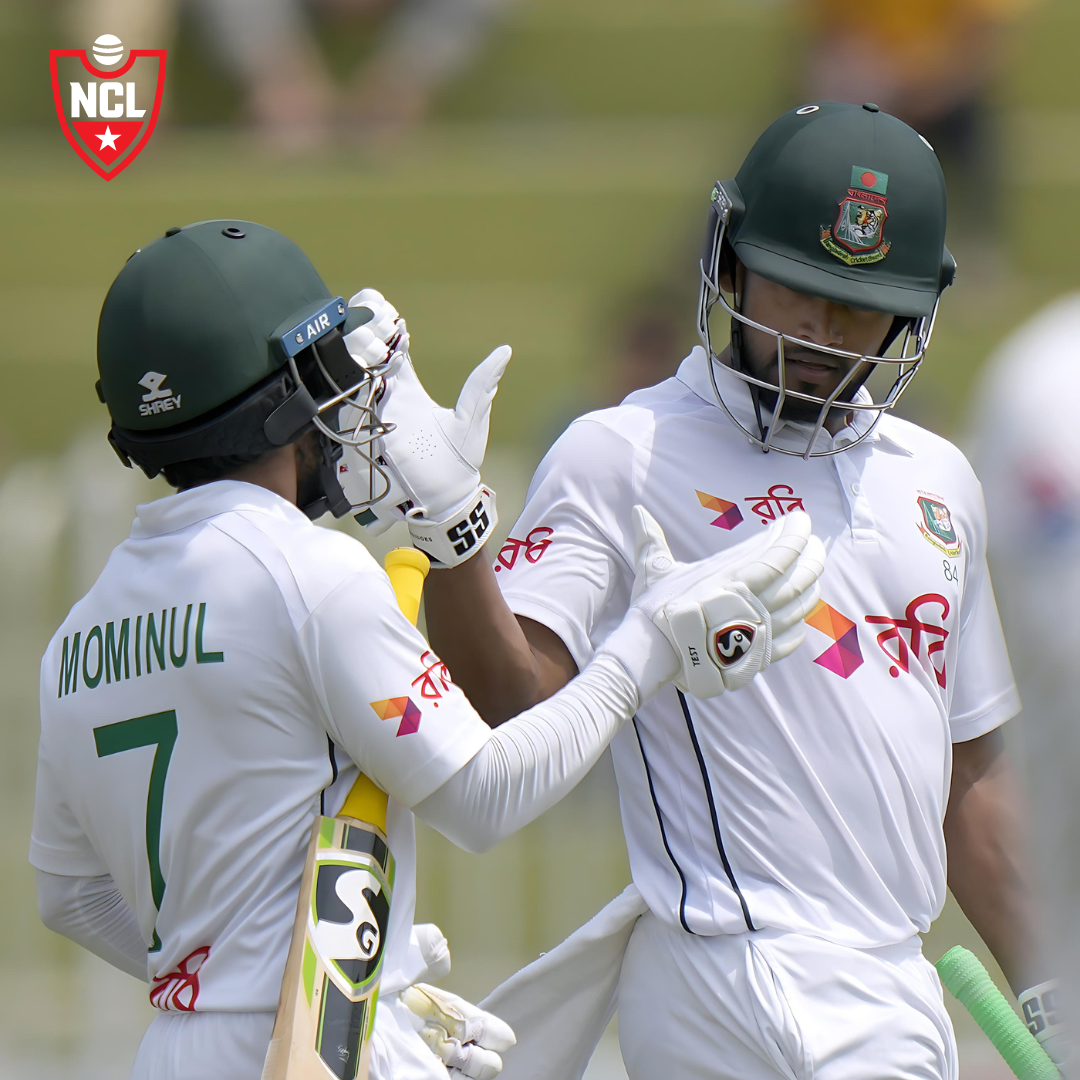 Najmul Hossain Shanto and Mominul Haque celebrating on the cricket field.