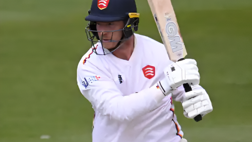 Tom Westley raising his bat after scoring a century in the County Championship.